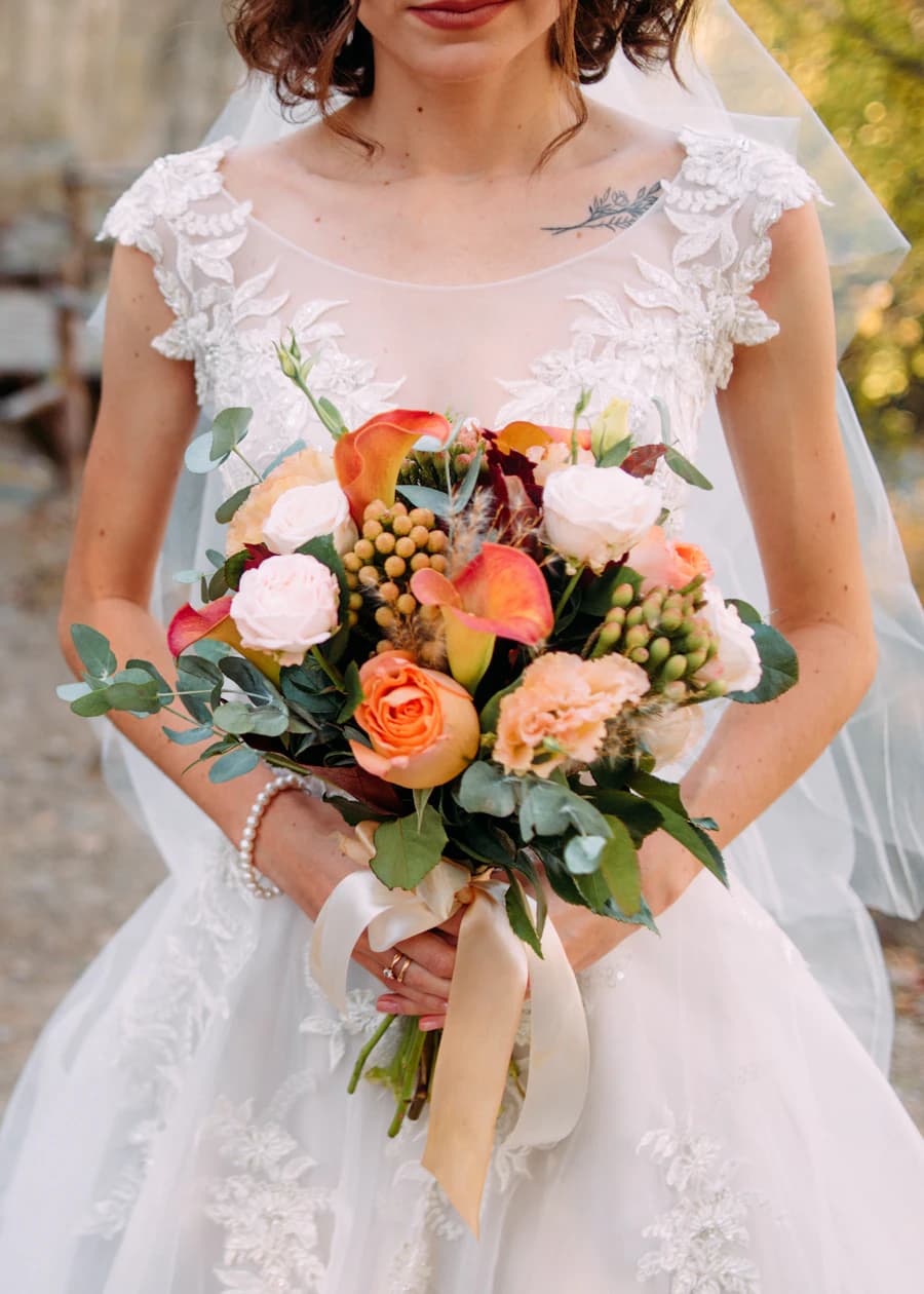 A bride holding a bouquet in a quiet, reflective moment
